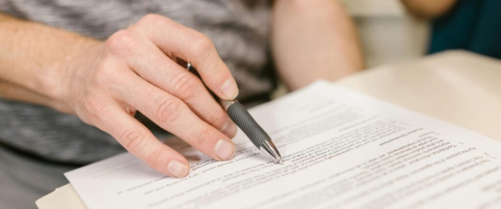 Man signing a caveat document for legal claim