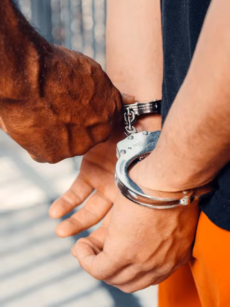 Police officer handcuffing person during arrest