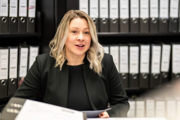 Businesswoman working in office with organised binders
