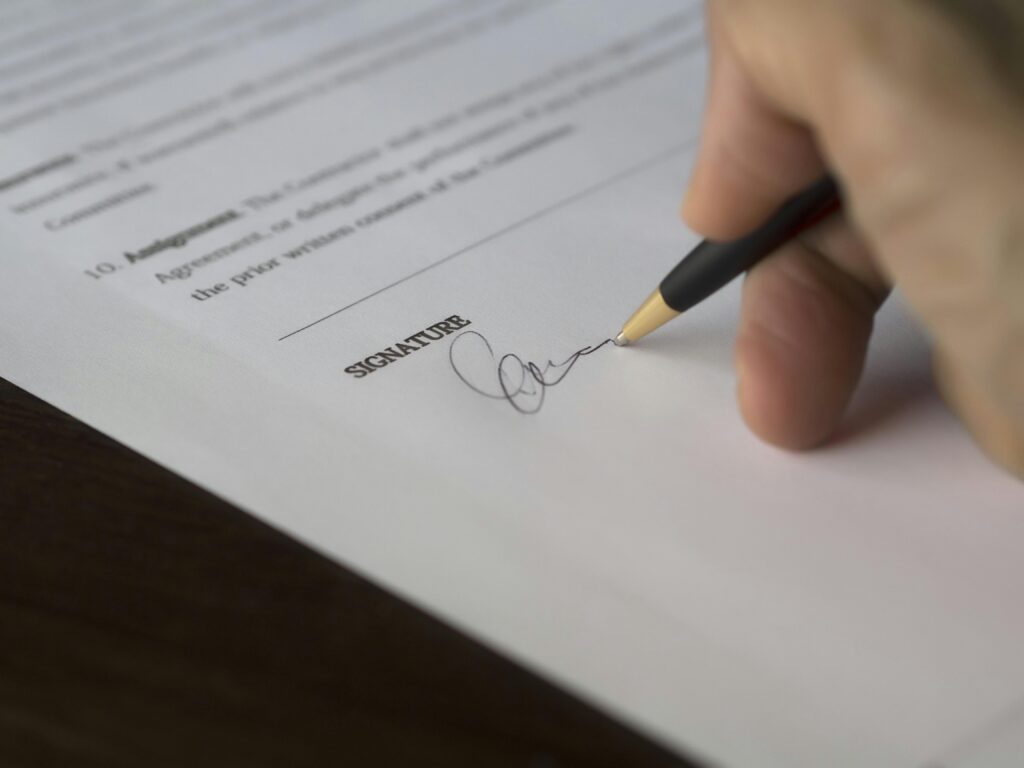 Person signing a document representing will and estate planning services
