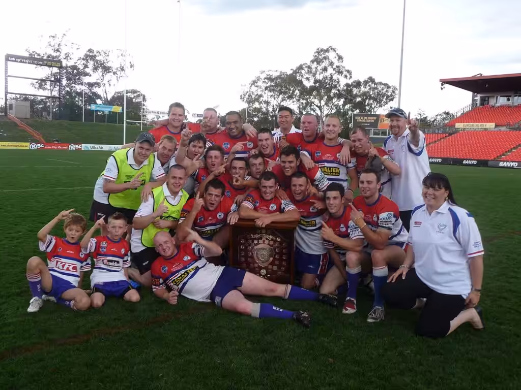 Group of people in sports attire smiling for a photo