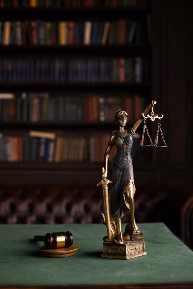 Statue symbolising justice beside a gavel