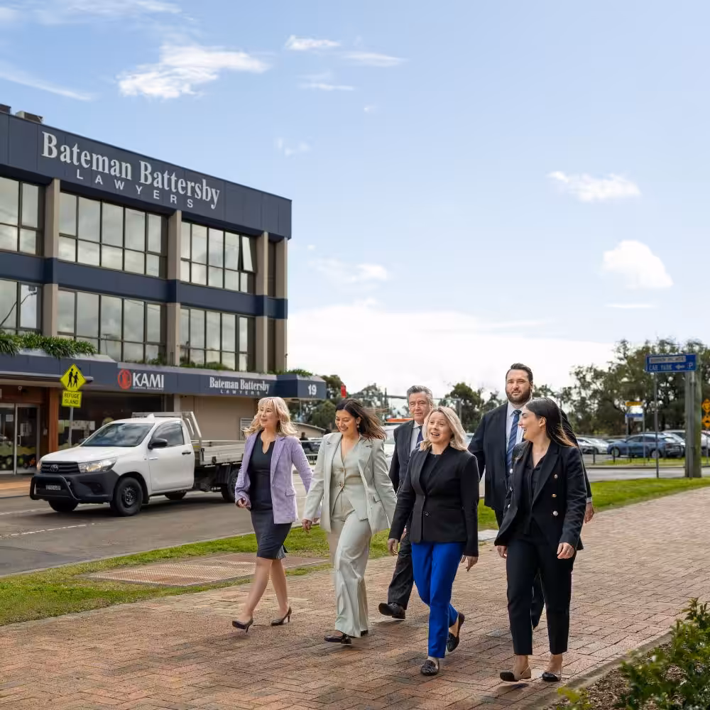 Employment law team walking outside the Bateman Battersby office building.