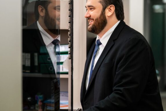 Smiling businessman in suit at office reception desk
