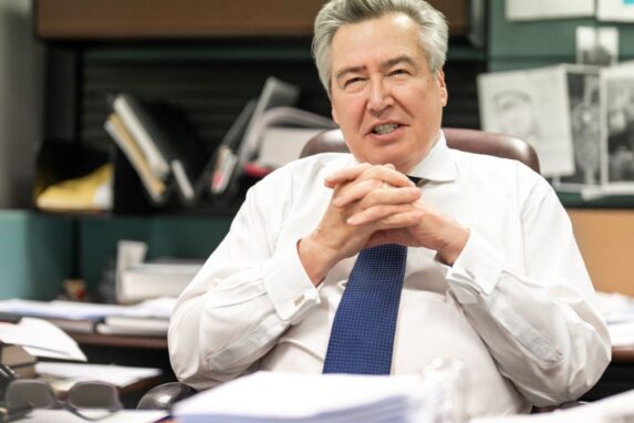 Businessman in office with documents on desk