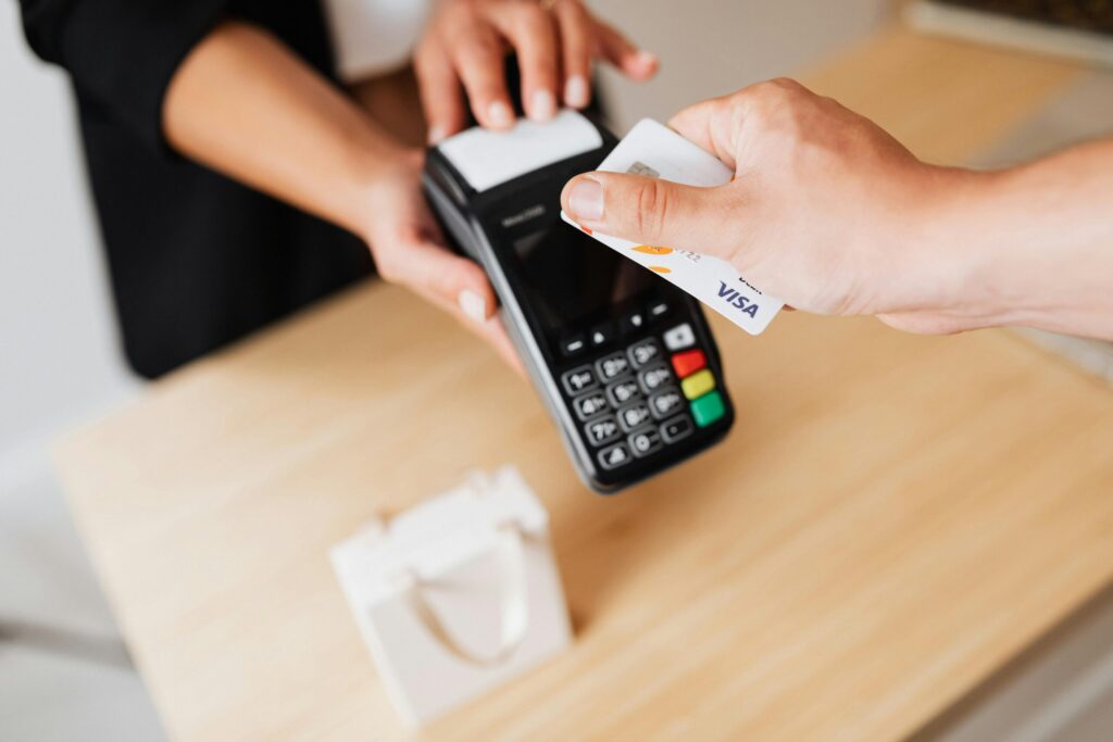 Person making contactless payment with Visa card
