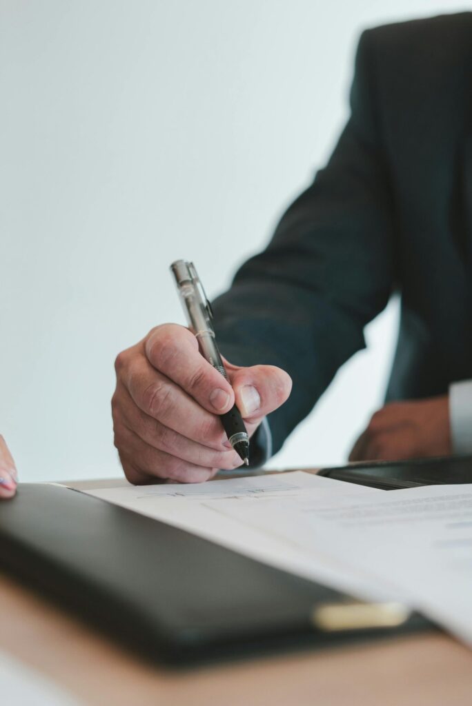 Businessman signing contract with pen